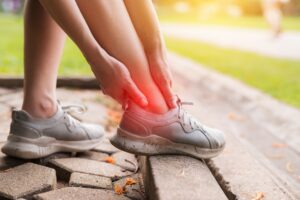 Runner experiencing ankle pain with highlighted pain area needing chronic pain treatment