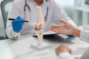 Healthcare provider examining joint during si joint pain treatment consultation