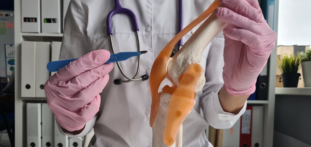 Doctor performing knee examination during bursitis knee treatment evaluation