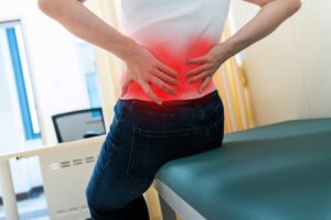 Lower back pain specialist doctor performing lumbar spine examination