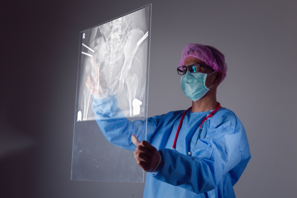 Surgeon performing minimally invasive hip replacement surgery using advanced techniques