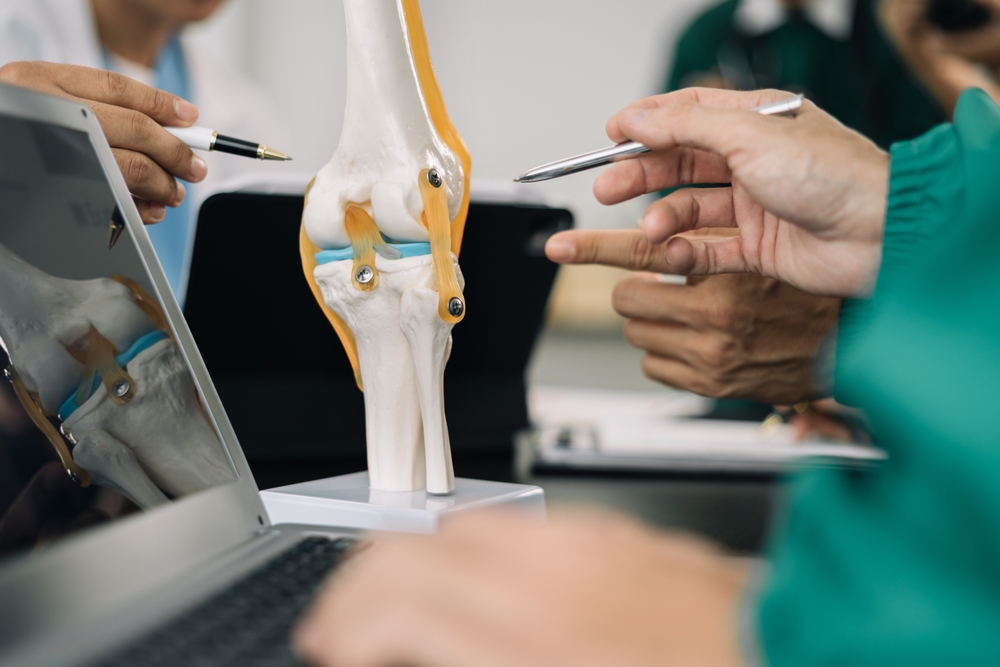 Surgeon performing minimally invasive knee replacement surgery with advanced instruments