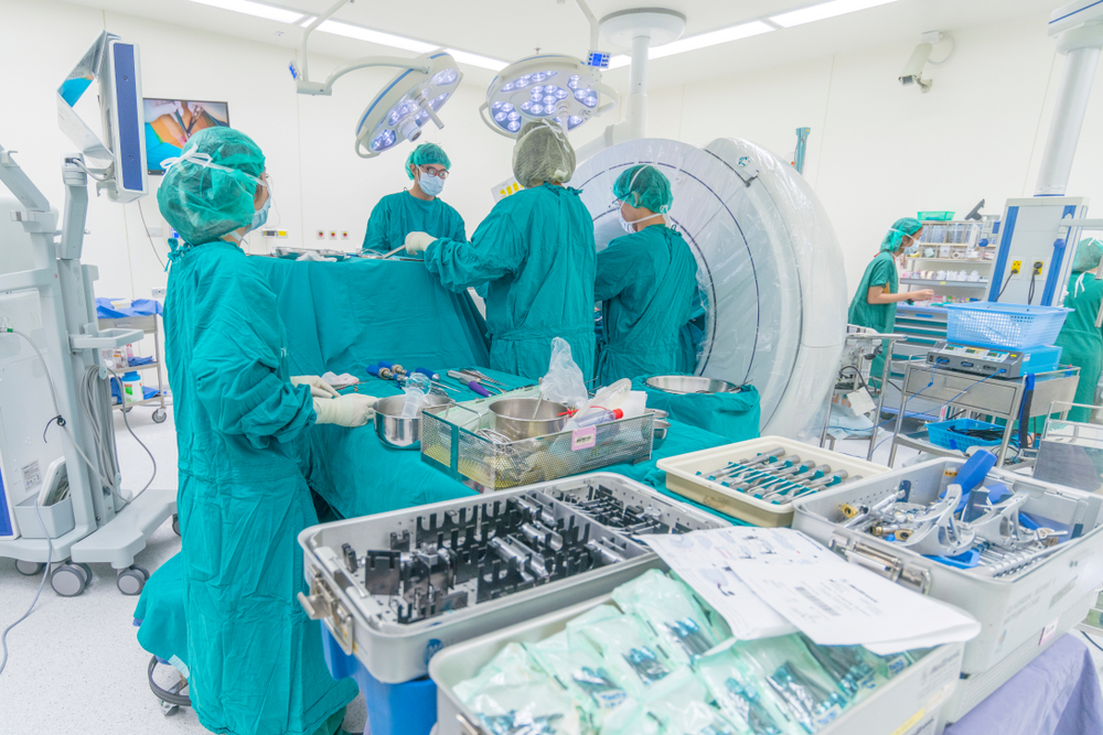 Surgeon performing minimally invasive spine surgery with specialized instruments