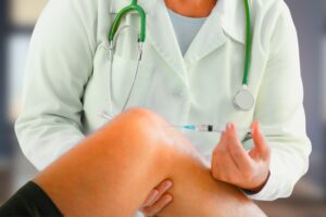 Medical professional preparing cortisone injections knee for patient