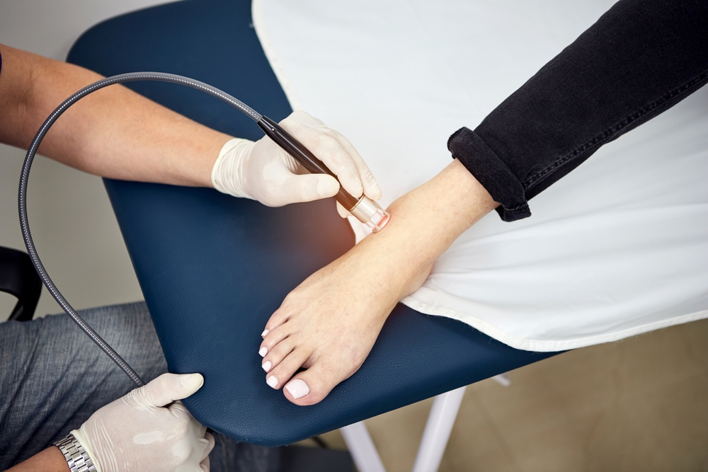 Foot pain specialist examining patient's foot during comprehensive evaluation