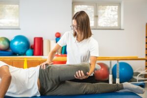 Orthopedic specialist examining hip during specialist for hip pain consultation