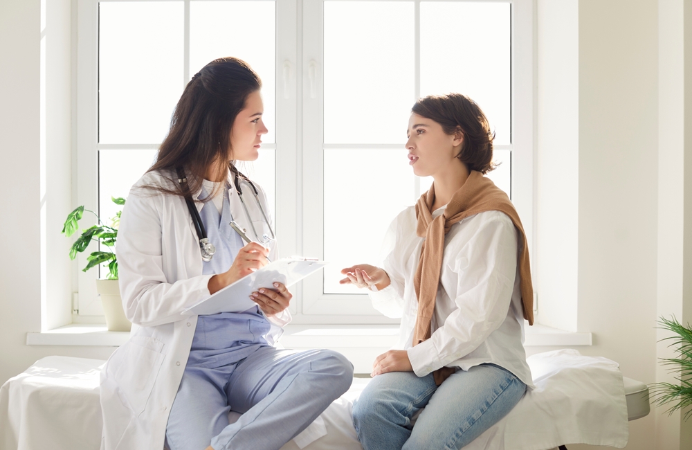 Doctor consulting with patient about amino acid therapy treatment options in clinical setting