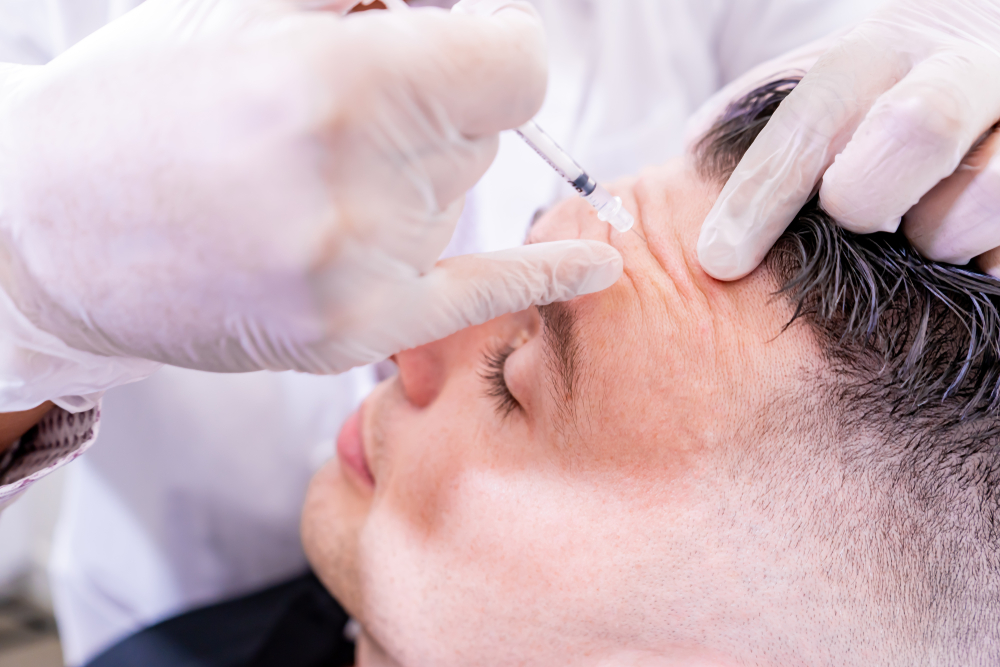 Healthcare provider performing Botox injection at migraine treatment site on patient