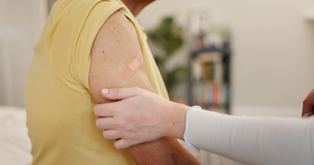 Healthcare provider examining patient's shoulder area before administering cortisone injection