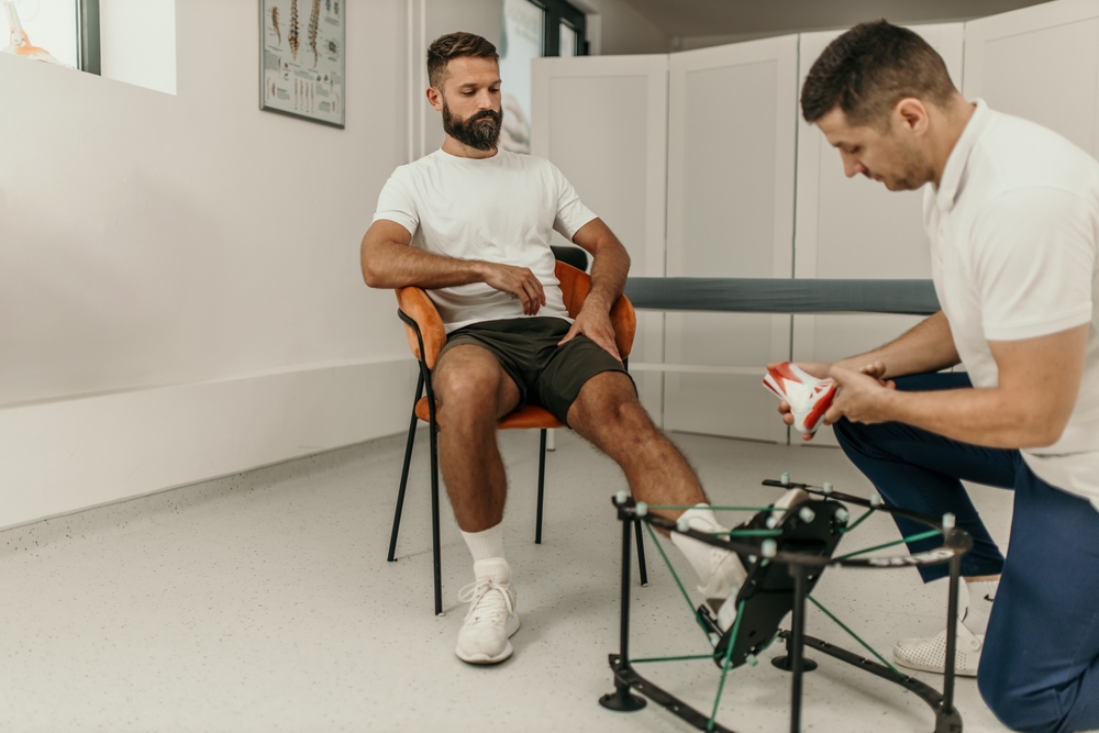 Healthcare provider assessing patient's foot for custom orthotic fitting