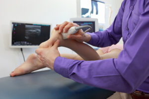 Healthcare provider performing diagnostic ultrasound examination on patient