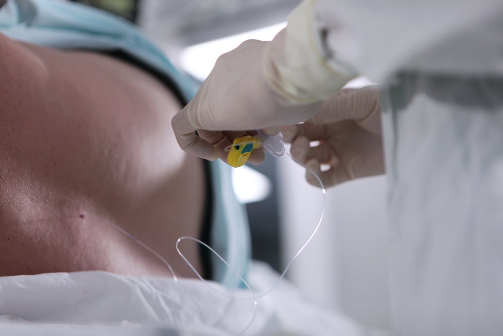 Physician administering epidural injection to patient's spine in clinical setting