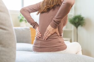 Doctor preparing epidural injection for patient experiencing back pain