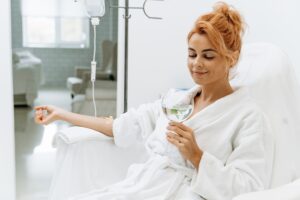 Relaxed woman receiving IV vitamin therapy infusion in comfortable setting