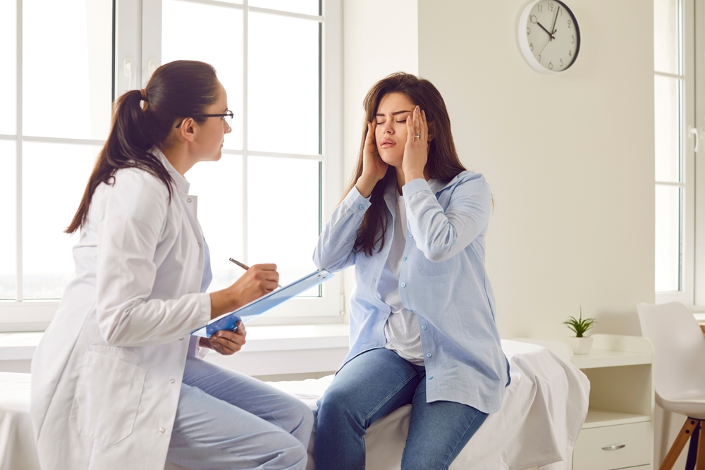Migraine doctor consulting with patient about headache treatment options