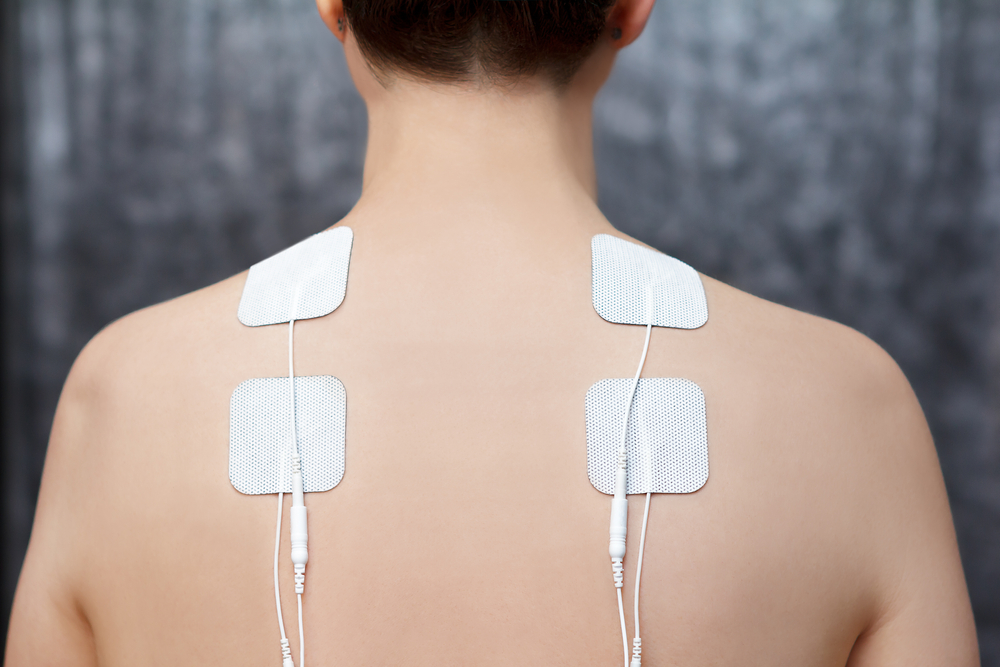 Therapist performing trigger point therapy for myofascial pain syndrome treatment