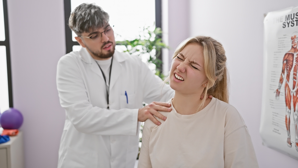 Neck pain specialist examining patient's cervical spine