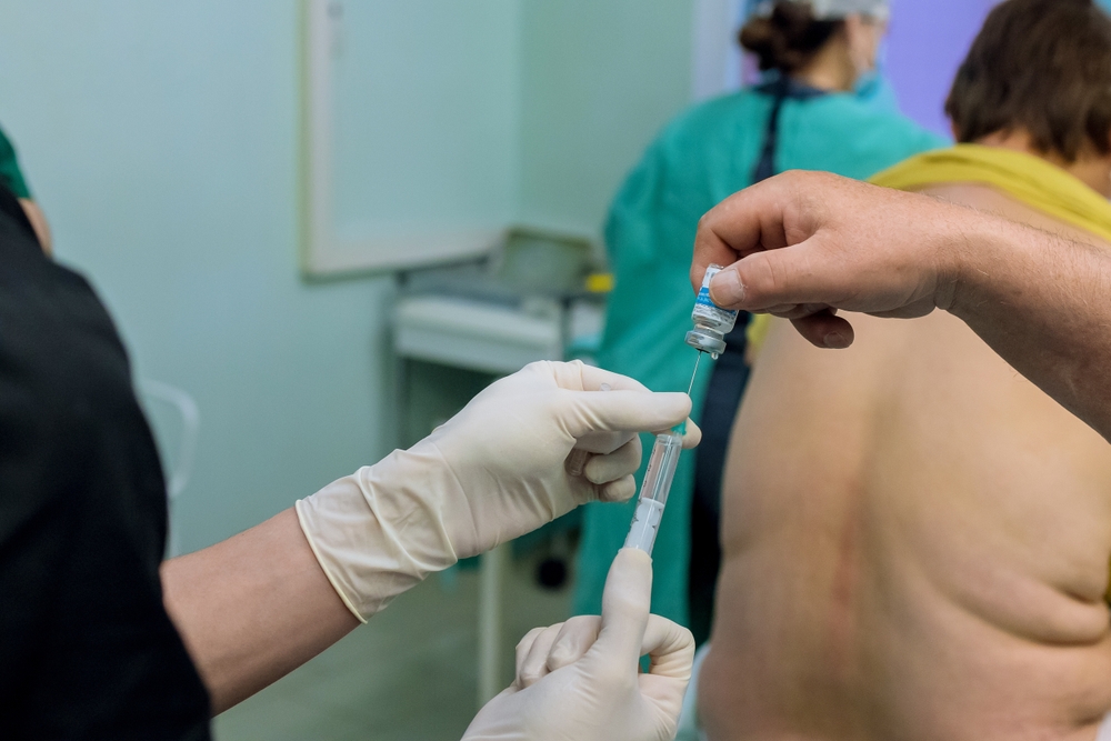 Medical professional performing nerve block injection procedure