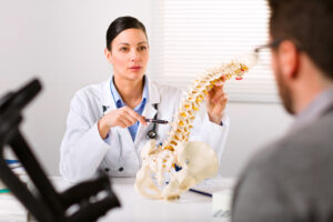 Orthopedic spine surgeon reviewing patient's spinal imaging