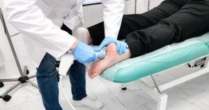 Patient receiving shockwave therapy treatment for plantar fasciitis heel pain