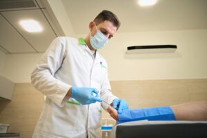 Podiatric surgeon performing foot surgery in operating room