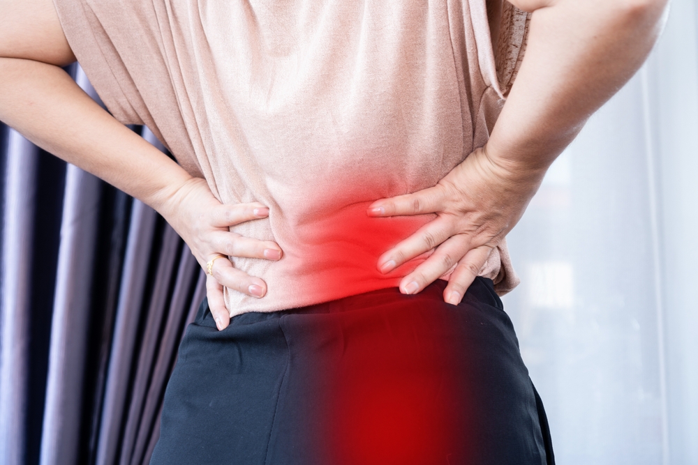 Patient receiving examination for sciatica treatment and leg pain