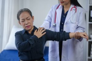 Doctor evaluating patient during shoulder injury evaluation nj