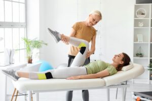 Sports chiropractor adjusting athlete's spine during treatment