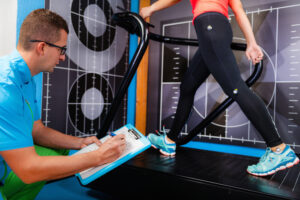 Doctor performing sports physical examination on young athlete
