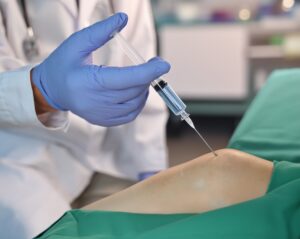 Physician administering Synvisc injection into patient's knee joint