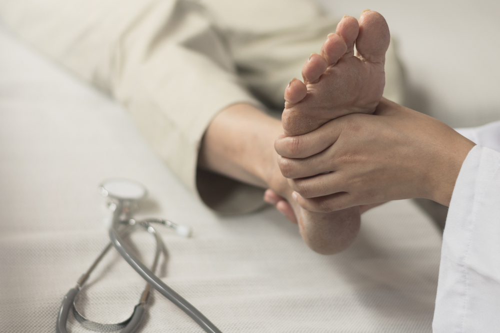 Healthcare provider assessing patient's foot for nerve compression