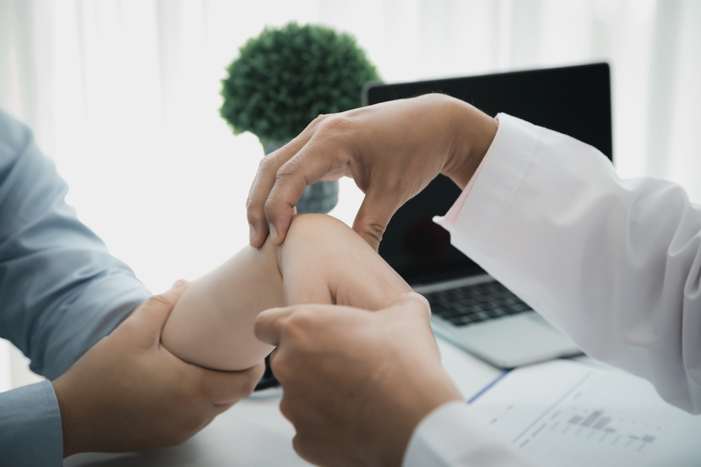 Medical professional examining hand tendinitis symptoms's hand and wrist during tendinitis of hand treatment consultation