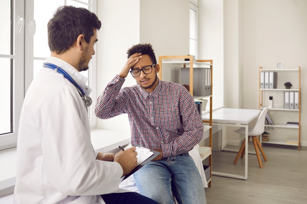 Patient receiving consultation for comprehensive migraine treatment plan