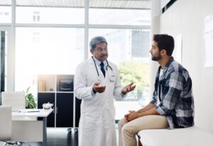 Medical provider consulting male patient about testosterone therapy