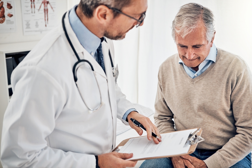 Doctor discussing TRT treatment options with male patient