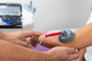 Sports medicine specialist examining pitcher's elbow for UCL injury