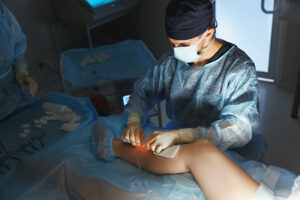 Vascular surgeon examining patient during consultation