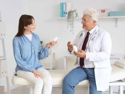 Medical professional preparing amino acid supplement powder for therapy infusion