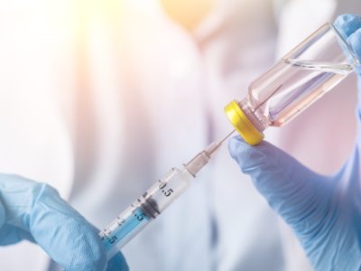 Healthcare provider administering therapeutic injection to patient in clinical setting