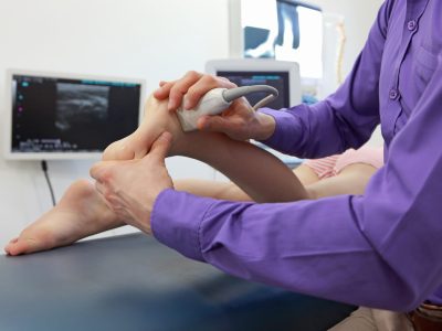 Healthcare provider performing diagnostic ultrasound examination on patient