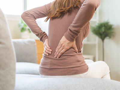 Doctor preparing epidural injection for patient experiencing back pain