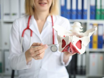 Medical professional demonstrating hip flexor pain treatment techniques