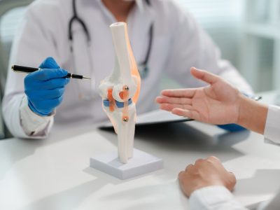 Healthcare provider examining joint during si joint pain treatment consultation