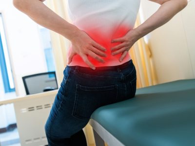 Lower back pain specialist doctor performing lumbar spine examination