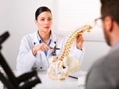 Orthopedic spine surgeon reviewing patient's spinal imaging