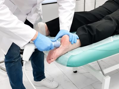 Patient receiving shockwave therapy treatment for plantar fasciitis heel pain
