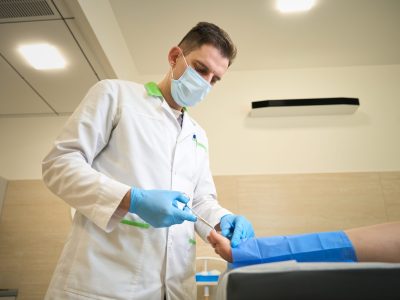 Podiatric surgeon performing foot surgery in operating room