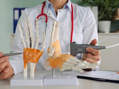 Doctor examining swollen joints during RA evaluation