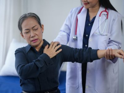 Doctor evaluating patient during shoulder injury evaluation nj