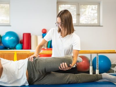 Orthopedic specialist examining hip during specialist for hip pain consultation